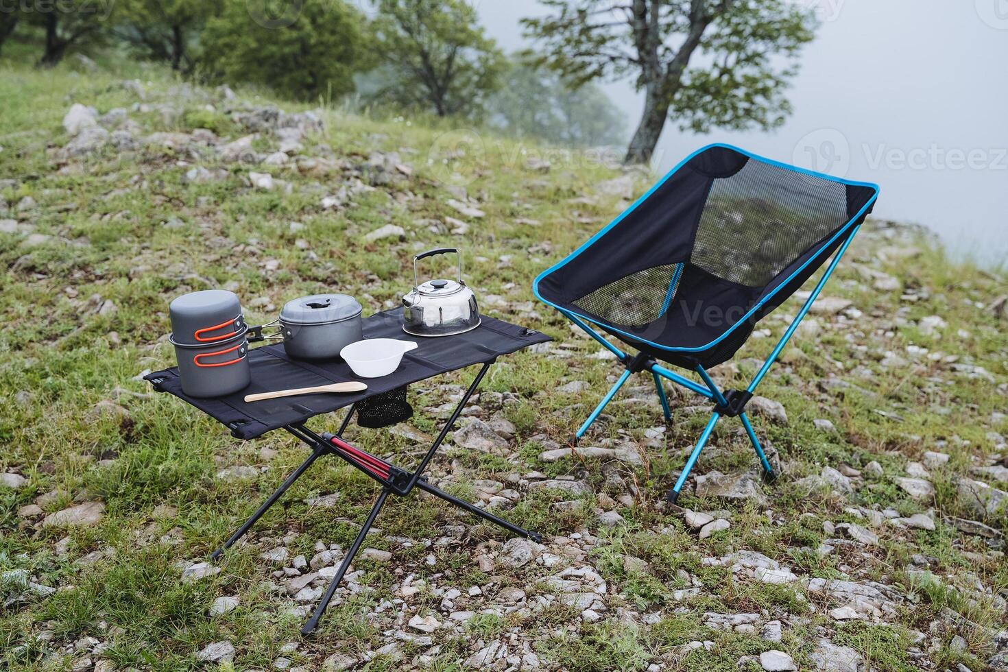 Decathlon -Decathlon tourist utensils for hiking are on the table compact equipment for outdoor recreation camping in the forest a place to relax in the mountains a folding chair photo